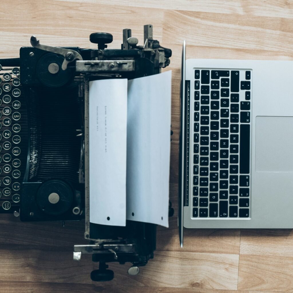 gray typewriter and MacBook