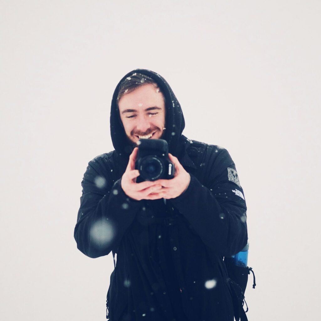 smiling man using DSLR camera